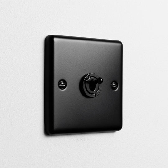 Matt Black Intermediate Toggle Switch On Light Grey Background