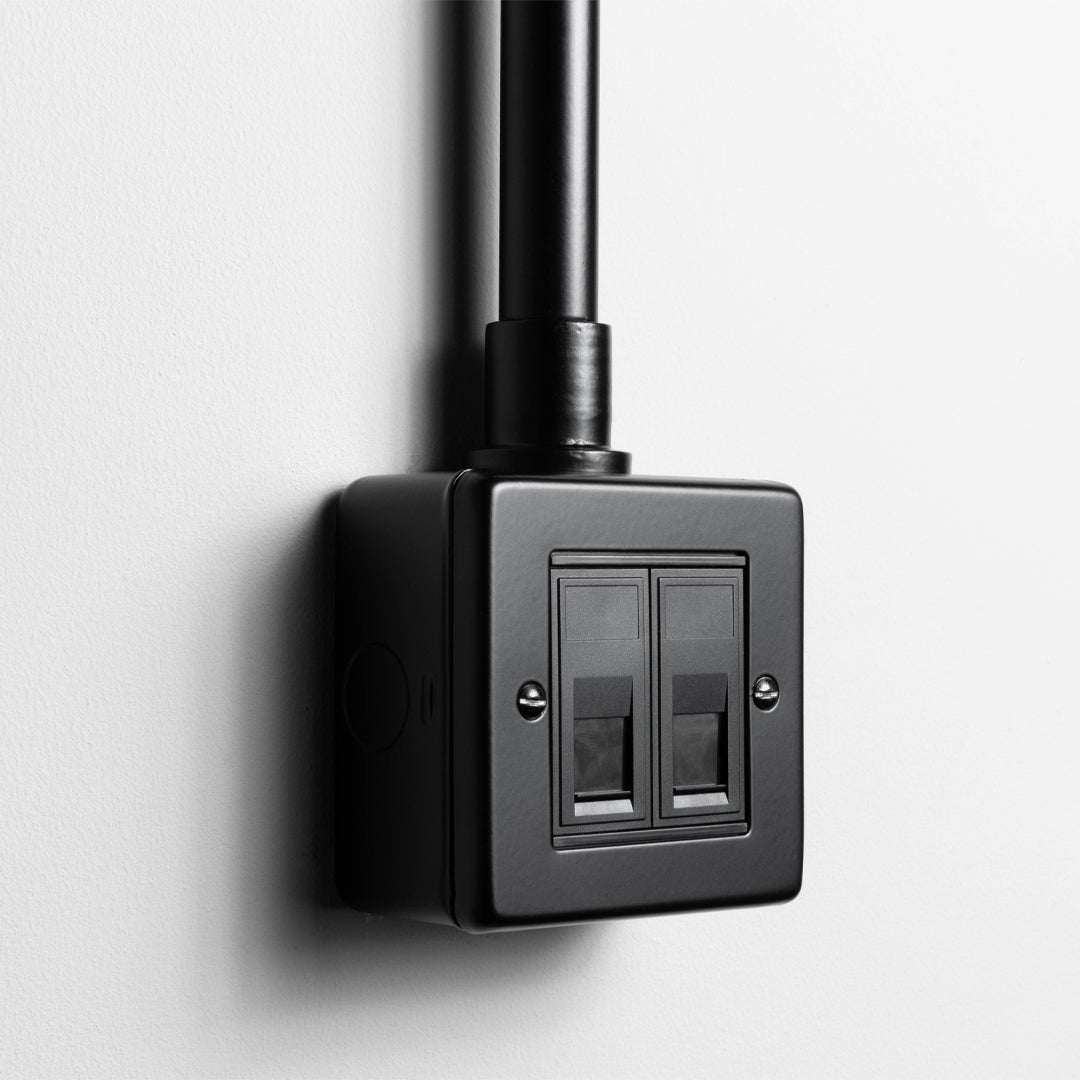 Matt Black 2 Gang RJ45 Socket With Back Box And Conduit On A Light Grey Background
