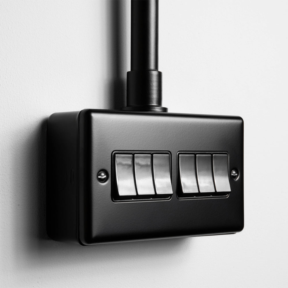 Matt Black 6 Gang 2 Way Switch With Black Insert With Back Box And Conduit On Light Grey Background