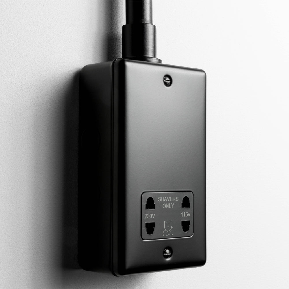 Matt Black Dual Voltage Shaver Socket With Back Box And Conduit On A Light Grey Background