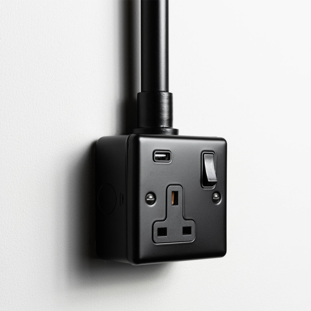 Matt Black Single Socket With USB With Back Box And Conduit On A Light Grey Background