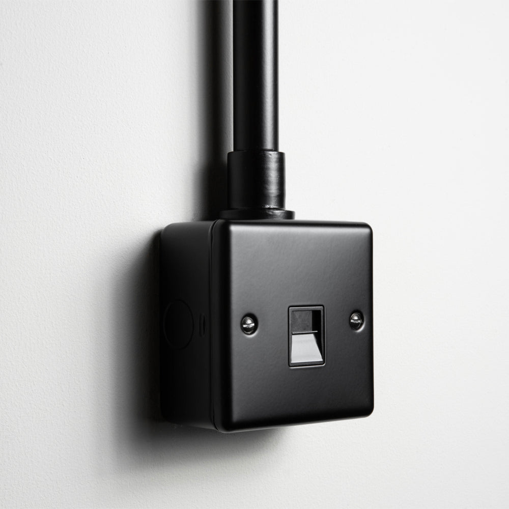 Matt Black Telephone Socket With Back Box And Conduit On A Light Grey Background