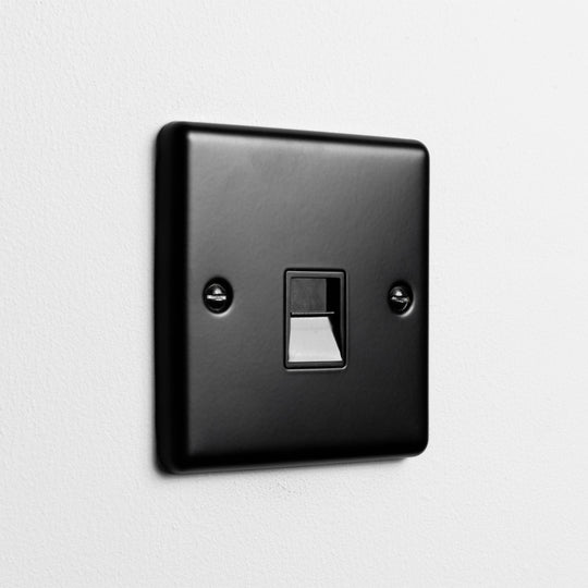 Matt Black Telephone Socket On A Light Grey Background