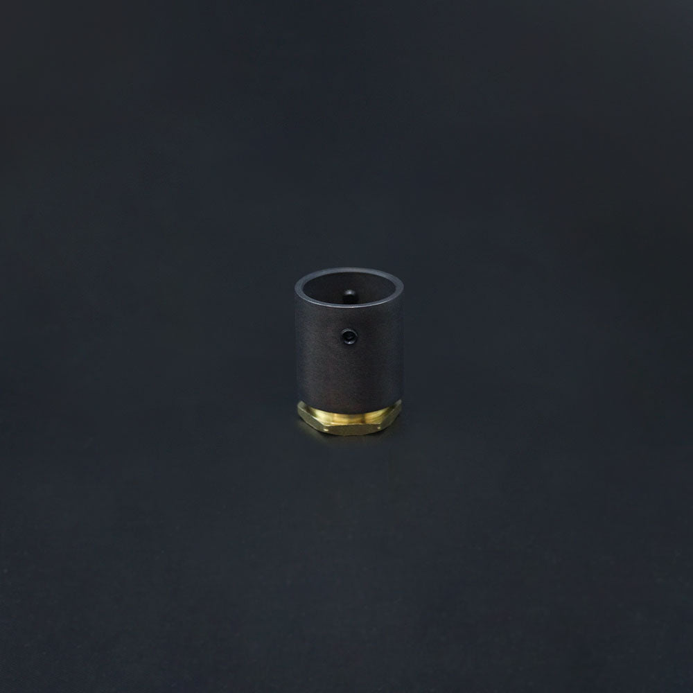 A dark bronze conduit adaptor with a brass base, displayed against a black background.