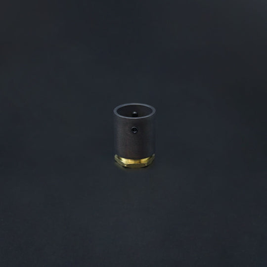 A dark bronze conduit adaptor with a brass base, displayed against a black background.