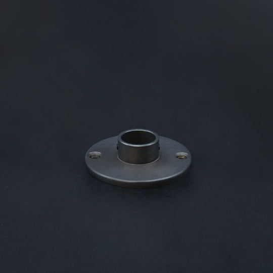 A dark bronze conduit dome cover on a dark background.